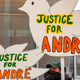 Black Lives Matter Activists hold signs outside the Franklin County Common Pleas Courthouse during the arraignment of Adam Coy, the former Columbus Police officer who shot and killed Andre Hill, in Columbus, Ohio on February 5, 2021.